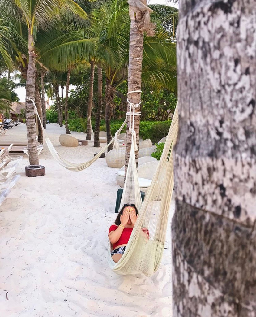 Me on a hammock covering my face in Cancun